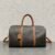 MEDIUM TRAVEL BAG IN TRIOMPHE CANVAS AND CALFSKIN